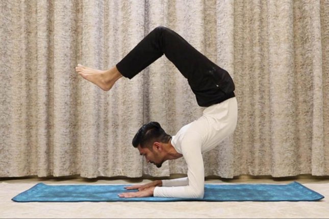 Yoga teacher holds scorpion pose for 29 minutes, shatters world record