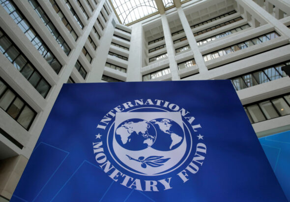 Nigeria growth forecast IMF headquarters building interior with large IMF logo sign displayed in a modern atrium
